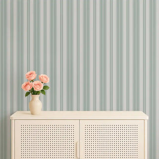 Subtle Mint Green & White Stripe Wallpaper Roll on a living room wall, paired with a white cabinet and a vase of pink roses, creating a refreshing backdrop.