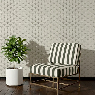 Suki Sofa and Chair Upholstery Fabric in green and beige vertical stripes, styled on a lounge chair.