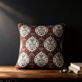 Single Gulmohar Sultan Garden Cushion displayed on a wooden surface in a dark room setting.
