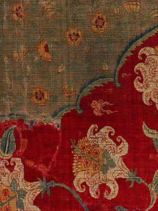 A close-up of the Sultana wall art showing a cream and saffron blossom on the worn crimson ground, below the cusped arch and olive rosette spandrel.