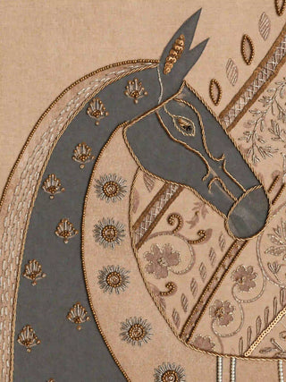 A detailed macro close-up of the Swarna Ashwa embroidered wall art highlighting the slate grey horse’s head outlined in gold beads and floral rosettes.