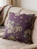 Taal Scallop cushion cover in dusty mauve with golden rope-piped scalloped edges, styled on a sofa.
