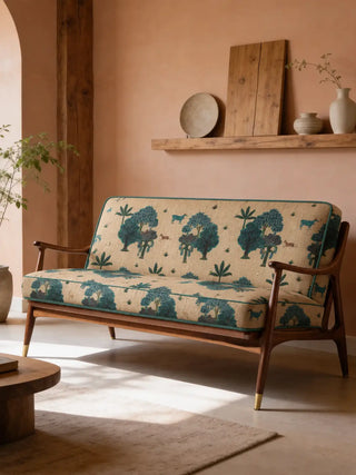 The Taal upholstery fabric in Cream & Blue on a mid-century wood-frame sofa in a terracotta-toned room.