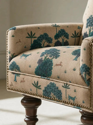 The Taal upholstery fabric in Cream & Blue on a mid-century sofa, styled in a warm terracotta living room.