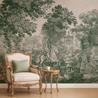A dark green European tapestry-style wallpaper featuring a scenic landscape with trees, architecture, and a horse rider, styled behind a vintage armchair.