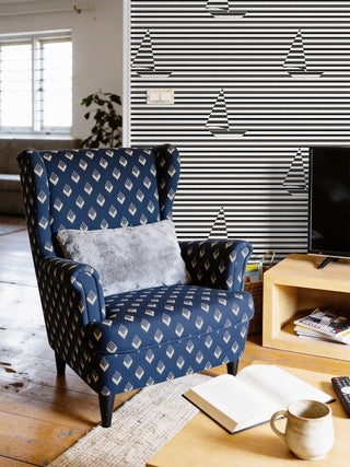 A luxury living room featuring the Tarang Indigo Wingback chair styled with a grey faux-fur cushion and a modern graphic mural.