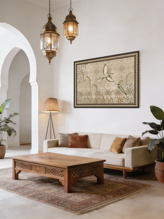 The Birds of Anqa custom framed canvas art piece creating a magnificent fine-art backdrop over a modern off-white sofa in an Arabian-style sitting room.