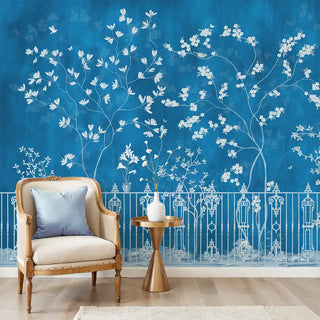 Room interior with a chair, table, and decorative wall mural on a blue wallpaper
