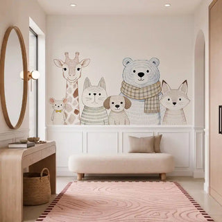The Cozy Crew kids wallpaper mural in Natural & Soft Neutrals installed on a feature wall in a nursery, showing illustrated mouse, giraffe, cat, dog, bear and fox characters above wainscoting. view-nursery