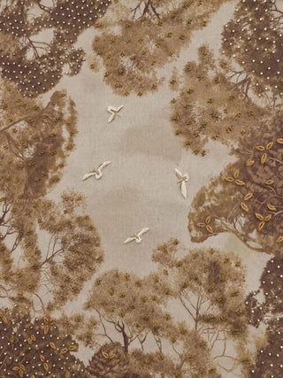 A detailed macro close-up of The Forest Nest embroidered wall art highlighting raised bird embroidery, beadwork and metallic-thread leaf detailing.