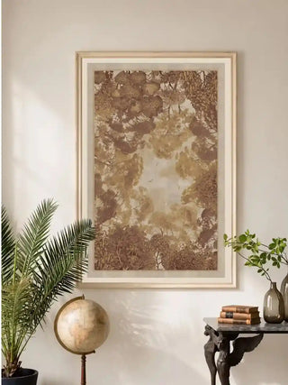 Framed The Forest Nest wall art beside a potted palm and marble console table in a neutral living room