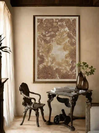 Framed The Forest Nest wall art above an antique table and carved wooden chair in a warm-toned reading nook