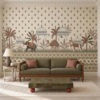 The Royal Caravan wallpaper with elephant, camel and horse behind an olive sofa and carved wooden frame in a living room, view-living-room