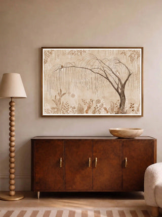 The Secret Garden wall art print in a thin wood frame above a burled wood sideboard with a wooden bowl, beside a beaded floor lamp and bouclé chair.