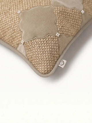 Close-up of the velvet diamond motifs, corded piping, and hand-strung pearl clusters on The Sirocco cushion cover