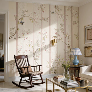 The Syntax of Spring pastel botanical and striped wallpaper styled inside a bright cottage-style living room next to a vintage wooden rocking chair.