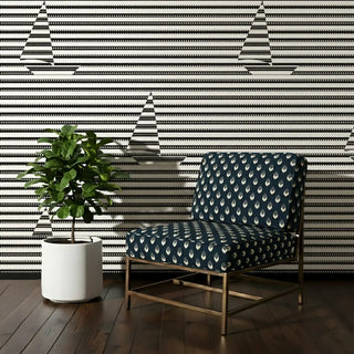 Trang Sofa and Chair Upholstery Fabric in navy with ivory motifs, styled on a lounge chair.