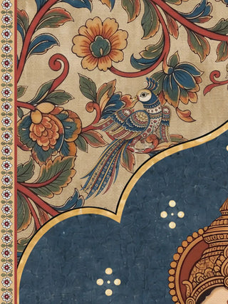 A close-up of the Trideva Mangalam wall art showing a long-tailed bird among red scrolling stems and orange and blue blooms above a scalloped blue arch.