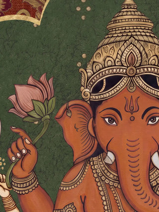 A close-up of the Trideva Mangalam wall art in Rust & Forest showing Ganesha's gold crown, face and lotus against the green arch.