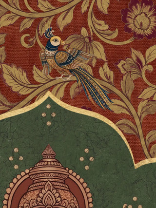 A close-up of the Trideva Mangalam wall art in Rust & Forest showing a peacock among gold floral vines on the rust-red border above a green arch.