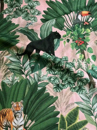 Draped Tropical Tales fabric highlighting the black panther, Bengal tiger, and vibrant toucan among monstera leaves.