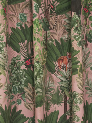 close-up detail of the Tropical Tales fabric showing a tiger and lemur among lush fan palms and pink hibiscus. (readymade curtain)