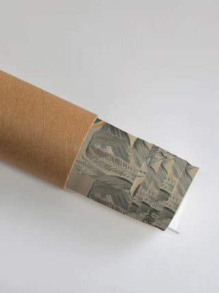 Premium protective packaging tube showing the rolled Tropical Vintage art print and its botanical leaf detail.