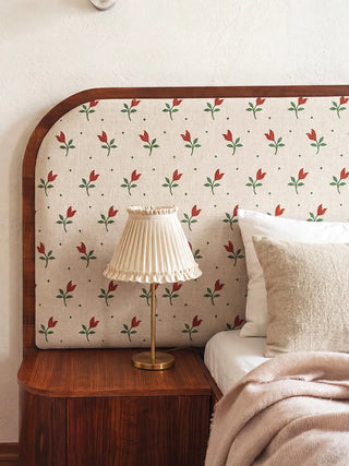 A luxury master bedroom featuring a custom curved headboard upholstered in the Tulip Field fabric.