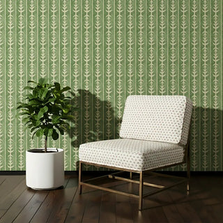 Accent chair upholstered in Tulip Field Fabric with a soft cream base and delicate tulip motifs, styled against a green patterned wall.
