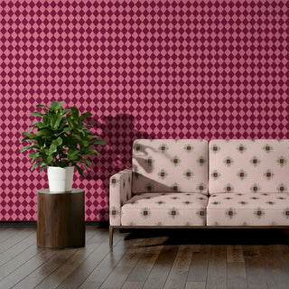 Sofa upholstered in Utsav Fabric featuring repeating floral design set against bold diamond wallpaper.