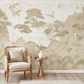 The Vana Geet sepia mural styled in a luxury living room behind a classic armchair and gold side table.