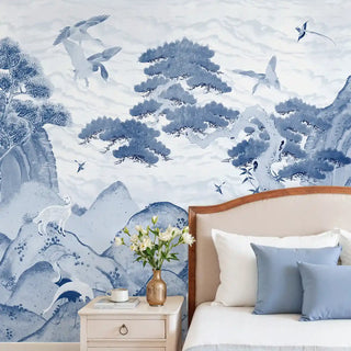 Bedroom with blue and white floral wall mural wallpaper, wooden headboard, and decorative pillows.