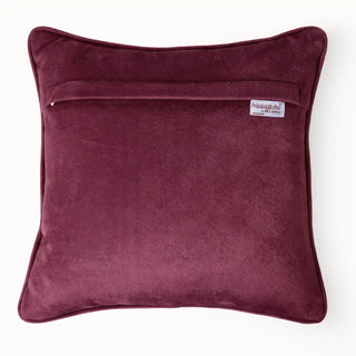 Back view of the Velvet Dune Cushion showing the solid tan velvet and brand label.