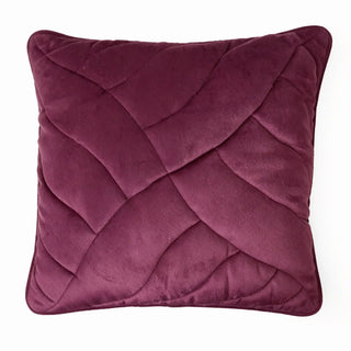 Full studio view of the fawn velvet cushion with three embroidered floral motifs.