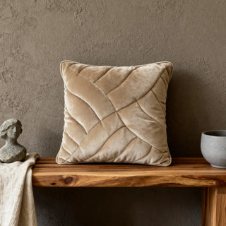 Single Velvet Dune Quilted Cushion Cover displayed on a wooden bench in a contemporary setting.