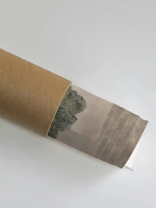 Vintage European Landscape wall art in sage green in rolled packaging, print visible at the mouth of a kraft shipping tube