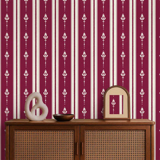Vintage Maroon & Beige Motif Stripe Wallpaper Roll covering a living room wall, styled with a cane cabinet, decorative mirror, and minimal accents for a warm interior look.