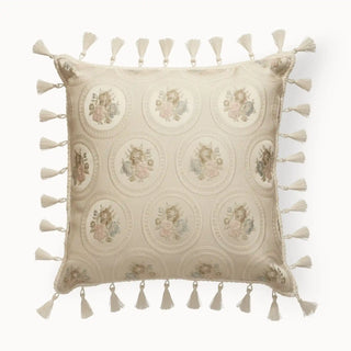 Beige cushion cover featuring intricate circular medallion motifs with pastel floral embroidery, finished with tassels along all sides.