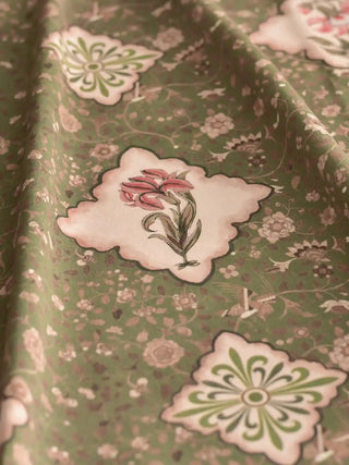 A draped view of the Viraasat Green textile showing the soft weave and rhythmic quatrefoil floral pattern.