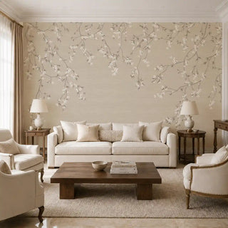 The Whispering Branches wallpaper mural in Sepia covering a feature wall in a living room behind a cream sofa and armchairs. view-livingroom