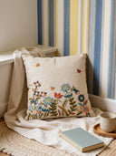 Whispers of Spring cushion cover with hand-embroidered wildflowers and butterflies on ivory linen.