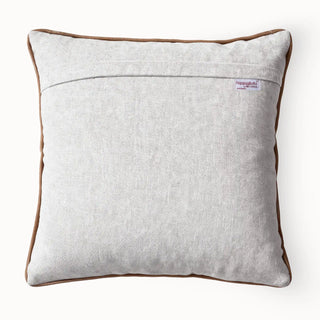 Solid light grey textured back of the Wild Blooms cushion cover showing the brand label.