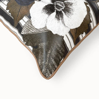 Close-up detail showing the cognac leather piping and the fabric texture of the floral motif.