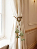 The Woodland Essence tieback styled on a cream linen curtain next to a sun-drenched window in a luxury room.