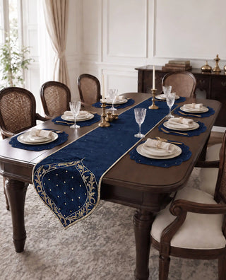 The Zarfshan Runner & Mats Set in Navy & Gold laid across a formal dining table for eight, with candlesticks and crystal glassware.