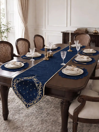 The Zarfshan Velvet Table Runner in Navy & Gold down the centre of a set dining table, with scalloped navy placemats.