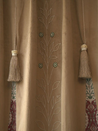 A macro shot highlighting the thick silk hanging tassels, pearl collars, and Mughal motif side borders of the Zarqash curtain panel.