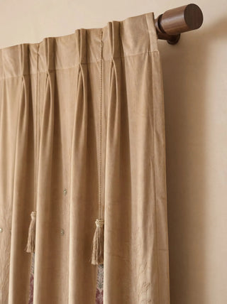 A detailed view of the precise pinch-pleats and hanging tassel details on the heading of the Zarqash custom velvet drape panel.