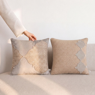 Pair of Zayan and Sirrocco hand-woven pillows featuring textured natural fibers with cream scalloped linen panels and diamond patchwork details in natural light.