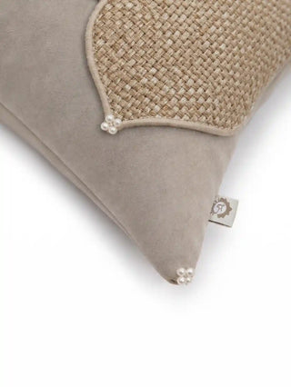 Close-up of hand-strung pearl clusters and corded piping along the jute weave edge of the Zayan Weave cushion cover